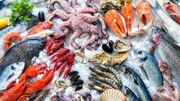 A variety of fresh seafood is pictured on ice